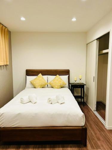 a bedroom with a bed with two towels on it at ASOBO OSAKA Kuromon 2nd in Osaka