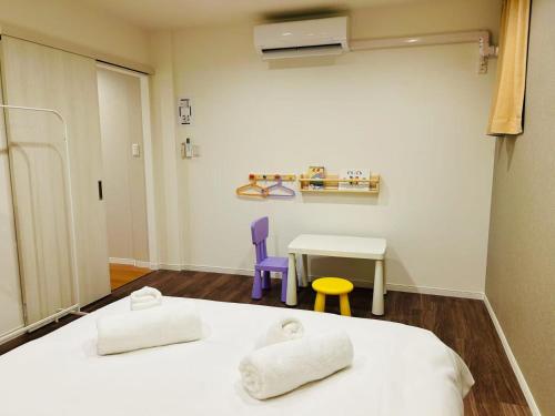 a hospital room with two beds and a table at ASOBO OSAKA Kuromon 2nd in Osaka
