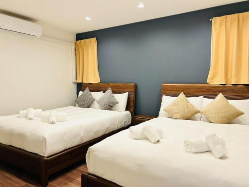 a bedroom with two beds with white sheets at ASOBO OSAKA Kuromon 2nd in Osaka