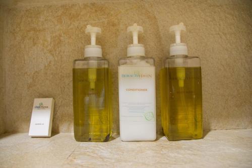 a group of three bottles of soap on a counter at Boracay Haven Suites in Boracay