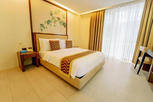 a hotel room with a bed and a window at Boracay Haven Suites in Boracay