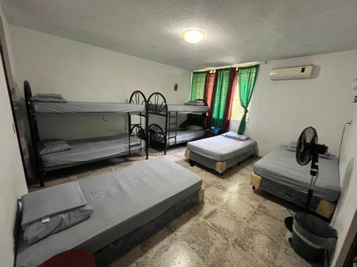 a room with three bunk beds in it at Hostal Cumbres de El Salvador in San Salvador