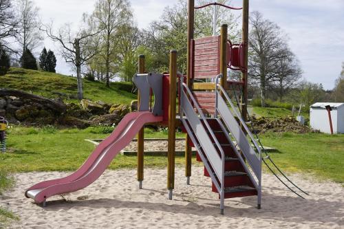 a playground with a slide in a park at House with playground visit Isaberg and High Chaparral in Dannäs