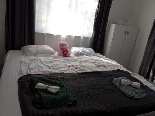 a pink teddy bear sitting on top of a bed at House with playground visit Isaberg and High Chaparral in Dannäs