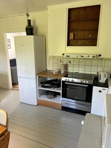 a kitchen with a refrigerator and a stove at House with playground visit Isaberg and High Chaparral in Dannäs
