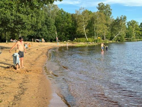 a group of people playing in the water on the beach at House with playground visit Isaberg and High Chaparral in Dannäs