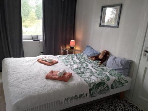 a bed with a teddy bear laying on it at House with playground visit Isaberg and High Chaparral in Dannäs