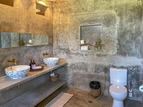 a bathroom with two sinks and a toilet at Baia Nest Villa 2nd FLOOR and LOFT within Self-Service Villa Near the Beach, Pet Friendly with a Fee in Gubat