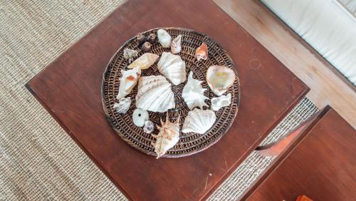 a plate of food on a wooden table at Baia Nest Villa 2nd FLOOR and LOFT within Self-Service Villa Near the Beach, Pet Friendly with a Fee in Gubat
