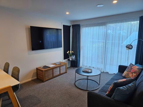 a living room with a couch and a table at Apartment in the Heart of Queenstown in Queenstown
