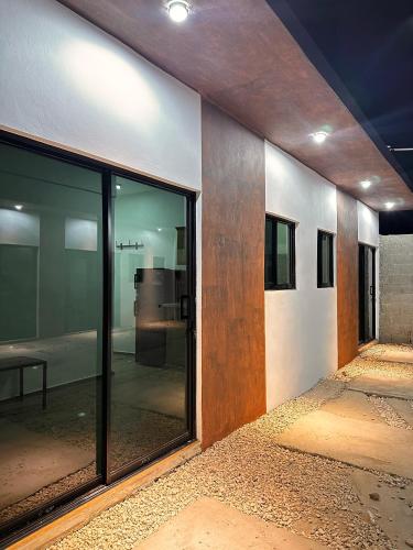 a room with sliding glass doors in a building at Residencial Fe y Esperanza in Pedernales