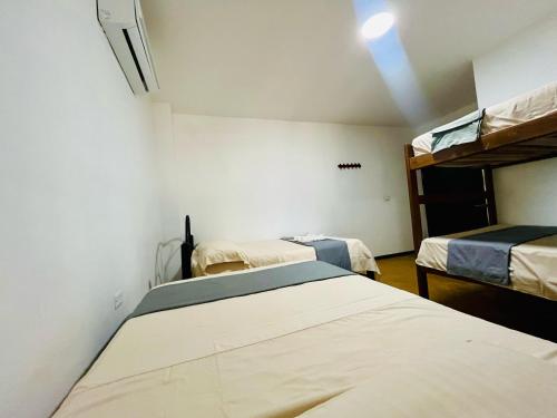 two beds in a room with two bunk beds at Verde Amanecer in Doradal