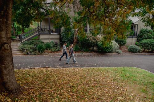 two young boys walking down a street at Candlebark at Boardwalk Villas in Metung
