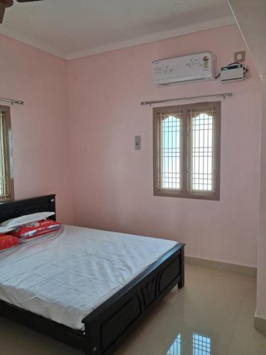a bedroom with a bed and a air conditioner at Home Stay in Ambasamudram Premika Bhavan in Ambāsamudram