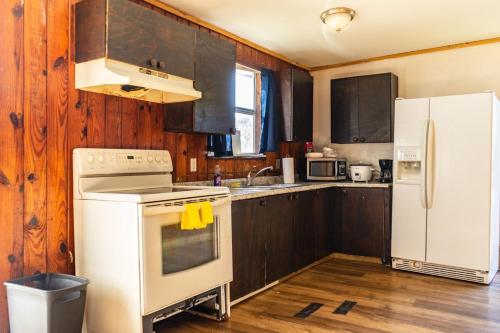 a kitchen with a white stove and a refrigerator at Downtown Fort Myers Retreat in Fort Myers