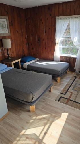 a bedroom with two beds and a window at Downtown Fort Myers Retreat in Fort Myers
