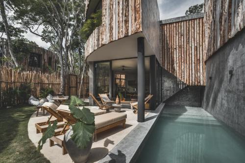 an external view of a house with a swimming pool at Jungle Luxury Villa Pvt Pool 100mbs AC Concierge D9 in Tulum