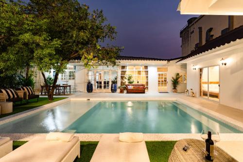 a swimming pool in the backyard of a house at APHRODITE POOL VILLA - Old City I 7 Bed Rooms I Daily Housekeeping in Chiang Mai