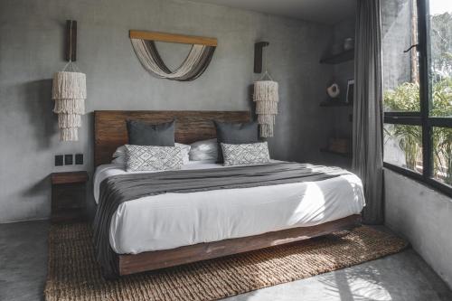 a bedroom with a large bed with white sheets and pillows at Jungle Luxury Villa Pvt Pool 100mbs AC Concierge D9 in Tulum