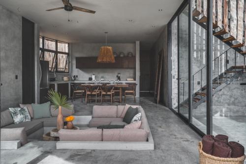 a living room with a couch and a kitchen at Jungle Luxury Villa Pvt Pool 100mbs AC Concierge D9 in Tulum