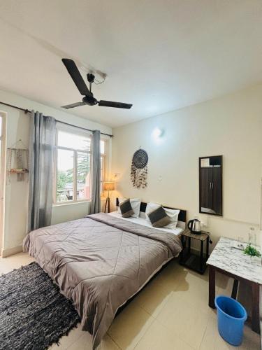 a bedroom with a large bed and a window at Rahgir Mcleodganj in McLeod Ganj