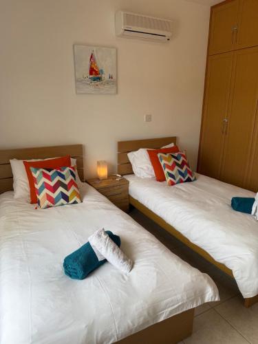 two beds sitting next to each other in a room at Green valley Tersefanou in Tersephanou