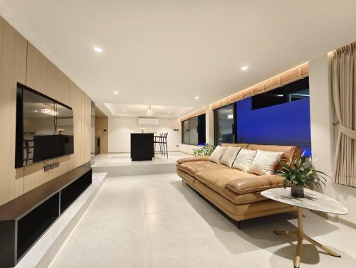 a living room with a couch and a table at Mountain breeze villa phuket in Ban Bang Khu