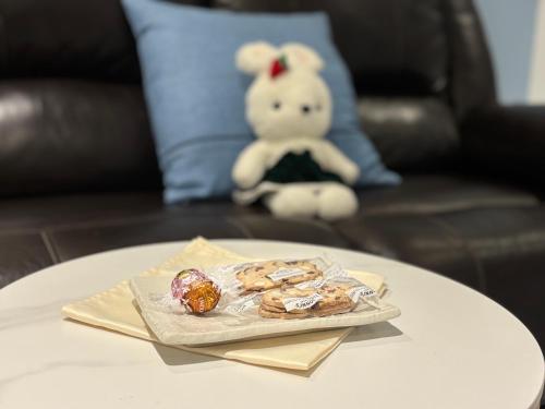a teddy bear sitting on a table with a plate of food at Fancy Family Suite with Parking near UBC in Vancouver