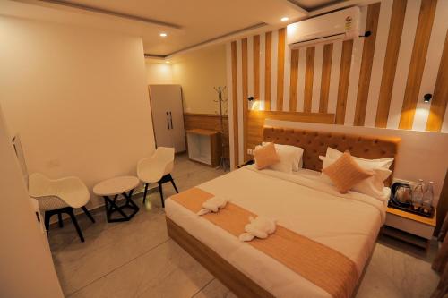 a bedroom with a bed with two stuffed animals on it at By the stream resort wayanad in Padinjarathara