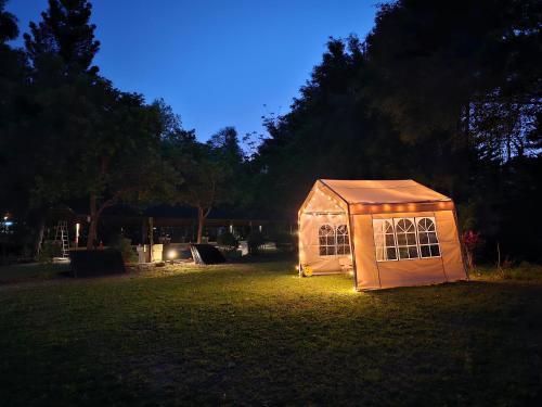 a small house with lights in a yard at night at Rainbow SpringYU B&B in Nanzhuang