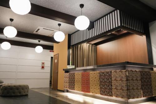a lobby with a waiting area with several lights at Guesthouse Sign in Kyoto