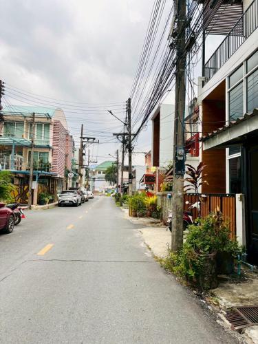 an empty street in a city with buildings at Dee Tee homestay hatyai in Ban Kohong