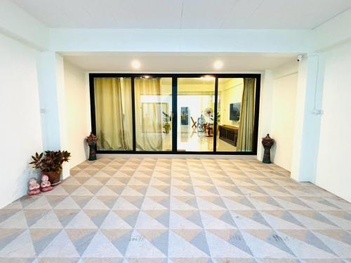 an empty room with a large glass door at Dee Tee homestay hatyai in Ban Kohong