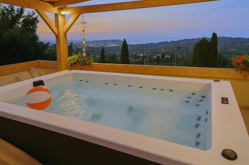 a jacuzzi tub on a deck with a view at Viros Holiday House Breathtaking Views & Private Mini Pool Jacuzzi in Corfu in Virós