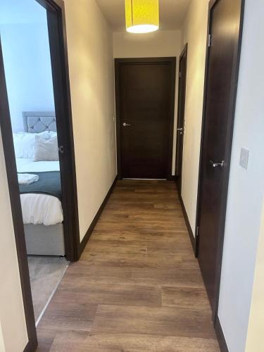 a hallway with a door leading to a bedroom at The Ivy Abode 2 bedroom ApartmentParking in Harlow