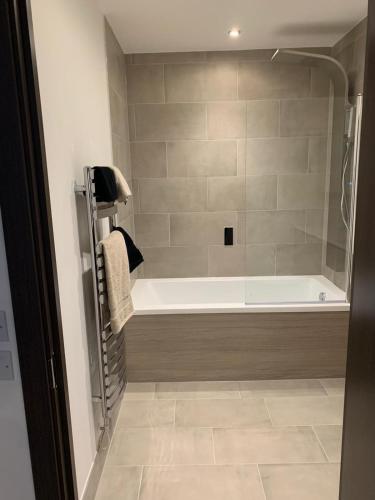 a bathroom with a bath tub in a room at The Sunrise Den-Lovely 2 bedroom apartmentParking in Harlow