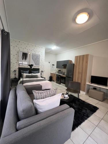 a living room with a couch and a bed at The Lagoon in Pretoria