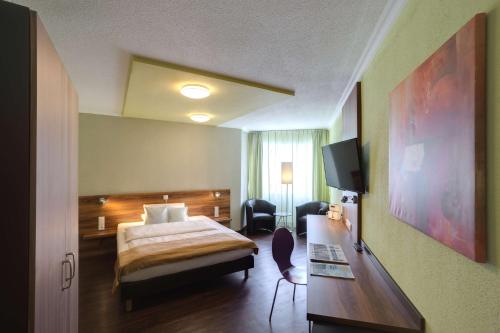 Postel nebo postele na pokoji v ubytování Best Western Hotel Ambassador