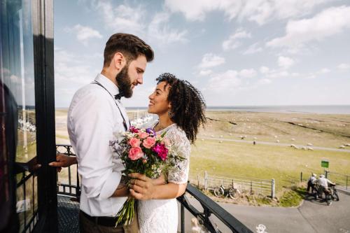 a bride and groom looking at each other on a train at Best Western Hotel Das Donners in Cuxhaven