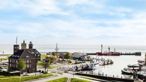 a view of a harbor with boats in the water at Best Western Hotel Das Donners in Cuxhaven