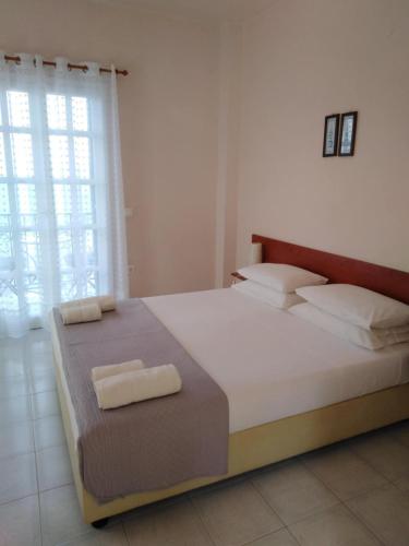 a bedroom with a large bed with two towels on it at Aprilis Apartments 2 in Kiónion