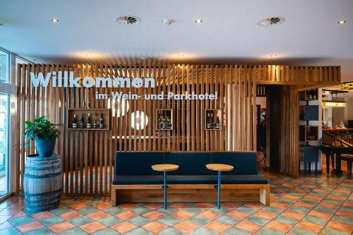 a lobby with a blue couch and two stools at Best Western Wein- und Parkhotel in Nierstein