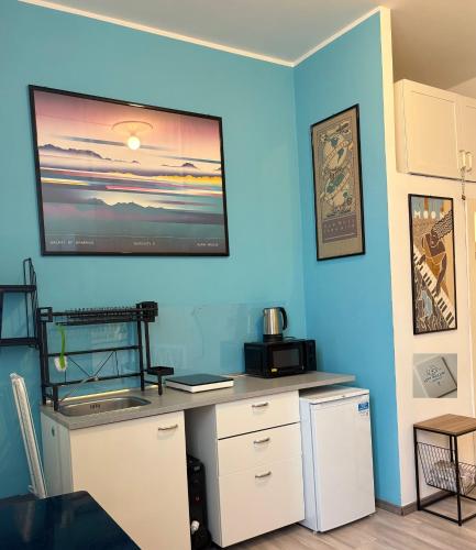 a room with a desk with a television on the wall at Loft Mazzini Rapallo in Rapallo