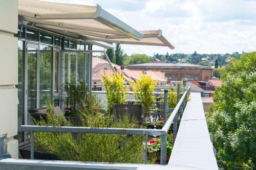 a balcony of a building with plants on it at Best Western Premier Grand Hotel Russischer Hof in Weimar