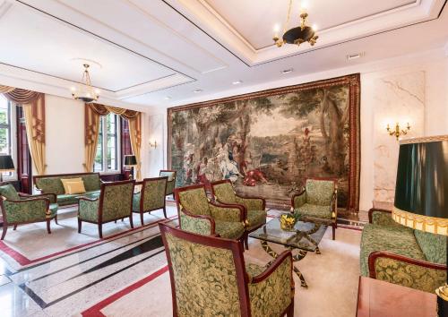 a drawing room with chairs and a large painting on the wall at Best Western Premier Grand Hotel Russischer Hof in Weimar