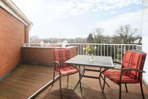 a balcony with a table and two chairs on a balcony at Best Western Hotel Heide in Oldenburg