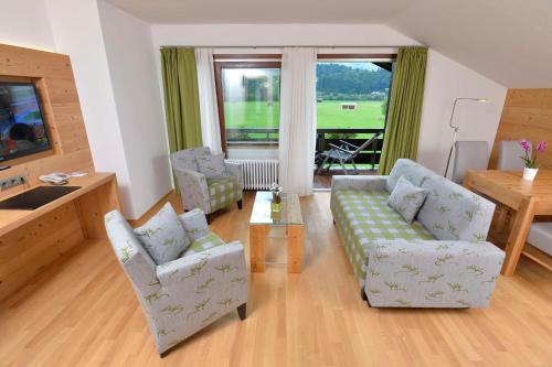 a living room with a couch and two chairs and a table at Best Western Plus Hotel Alpenhof in Oberstdorf
