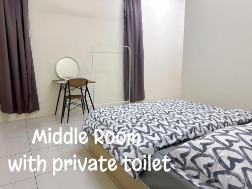 a bedroom with a bed with a black and white comforter at 365 Homestay in Kampong Lima Kongsi