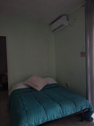 a bedroom with a bed with a blue blanket at Memela House in Poggio Mirteto