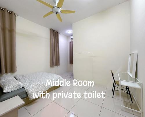 a bedroom with a bed and a ceiling fan at 365 Homestay in Kampong Lima Kongsi